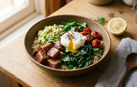 Warm tuna avocado breakfast bowl with poached egg, brown rice, and wilted spinach